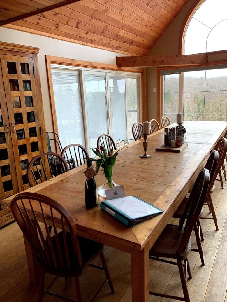 Long dining table beside the wine cabinet