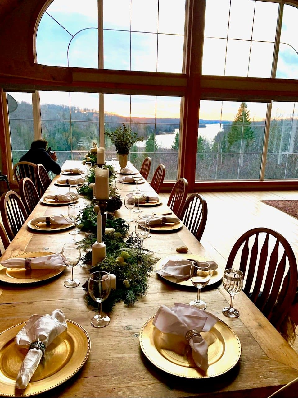 Dining table set for a holiday dinner with a lake view