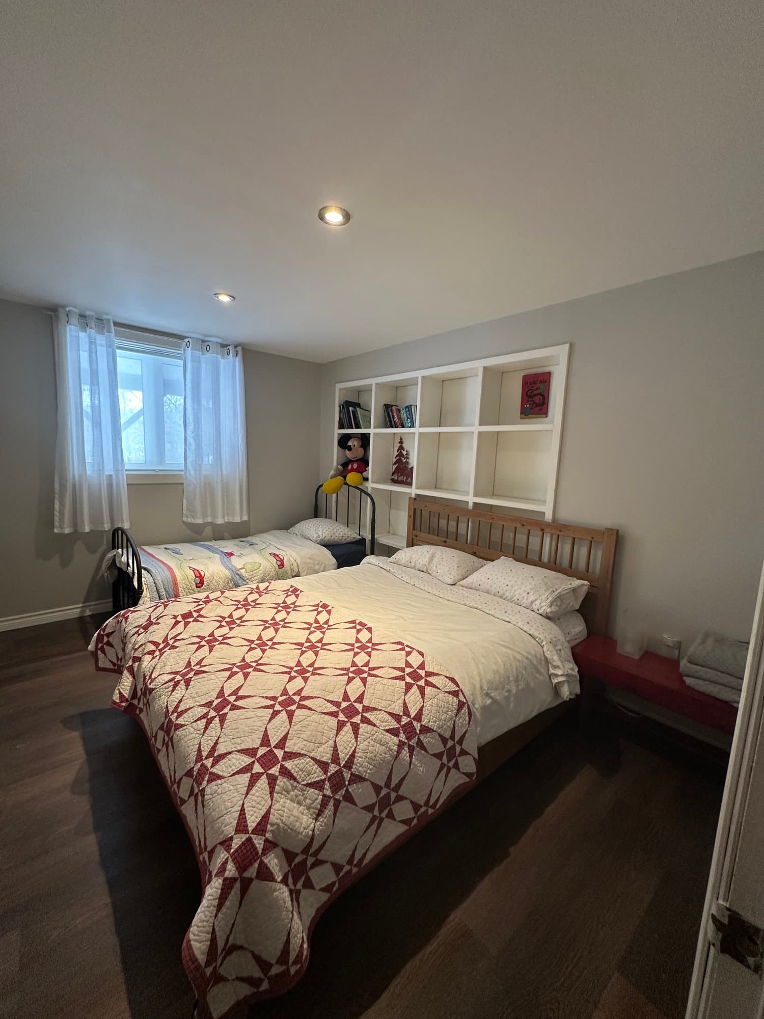 Bedroom with a red and white quilt