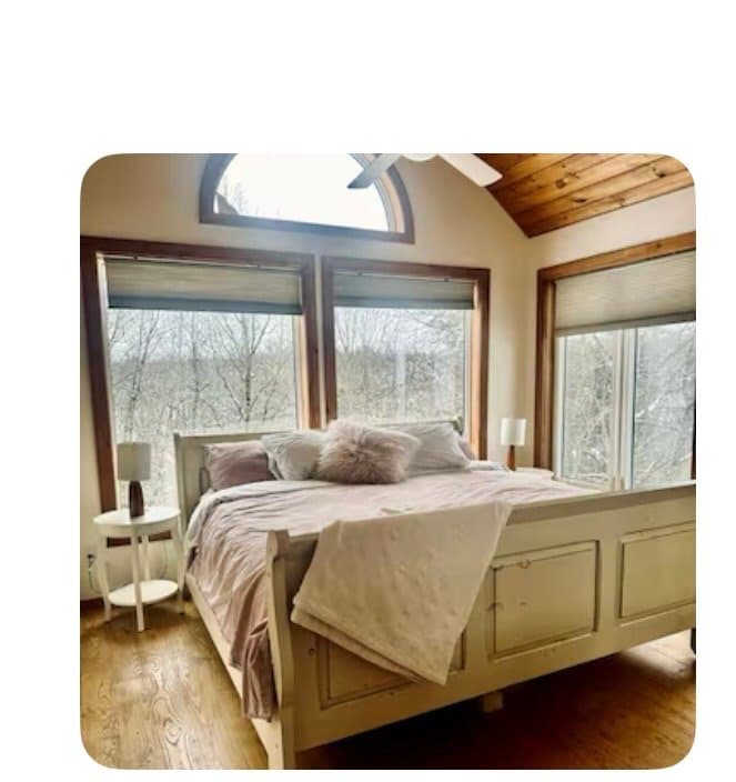 Bedroom with windows overlooking the trees