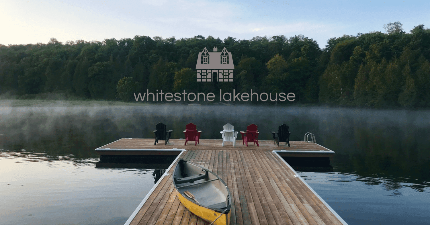Whitestone Lakehouse: the dock and a canoe on the lake at sunrise