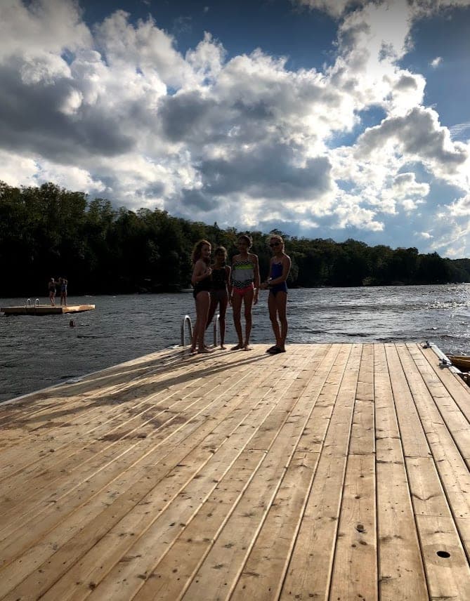 Friends standing at the end of the dock