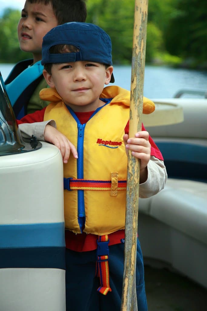 Child in a life jacket on a boat