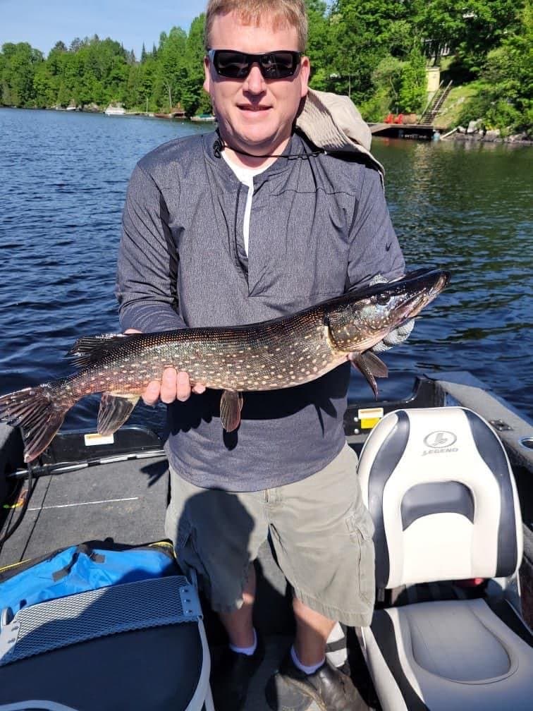 Angler holding a large pike