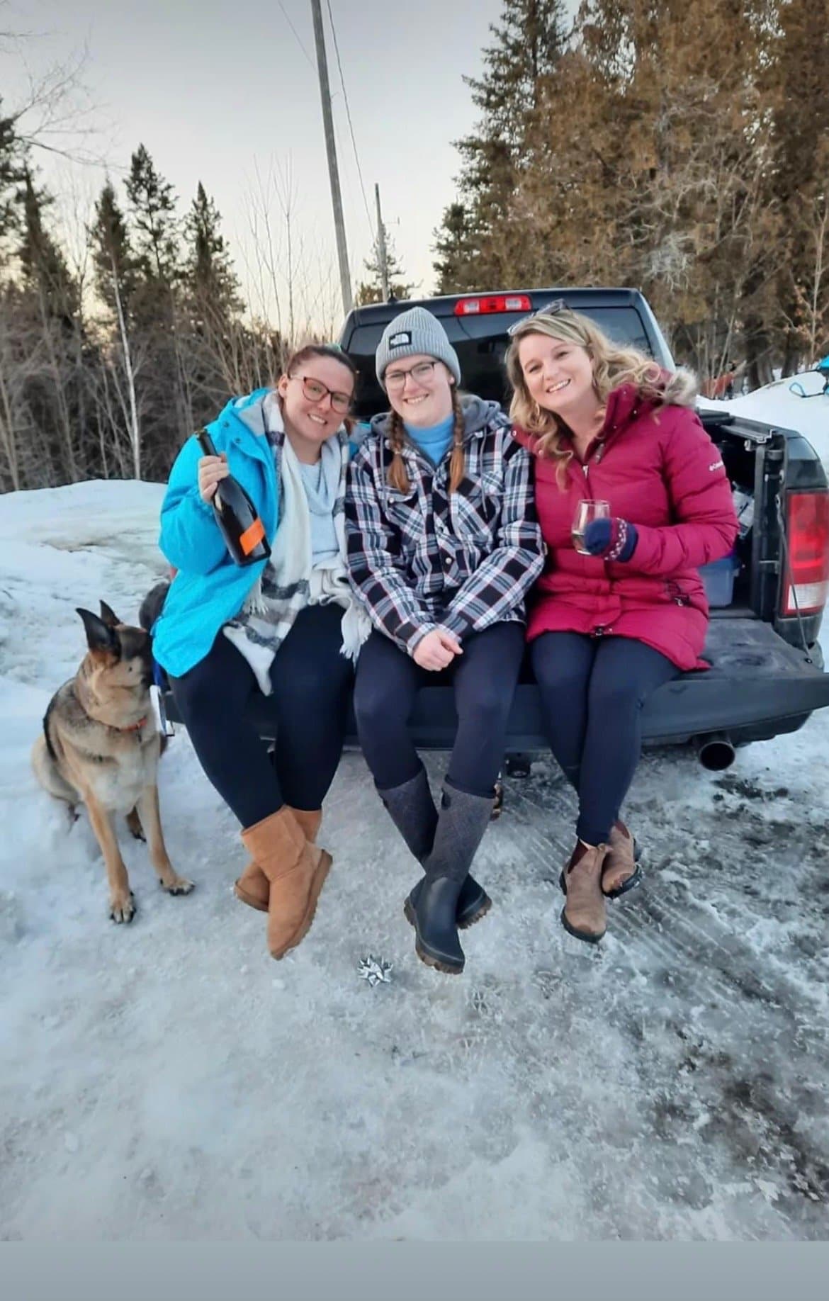 Friends and their dog in the snow