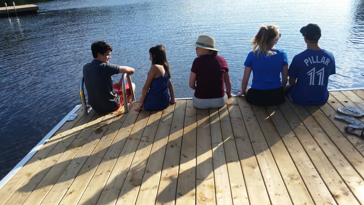 Friends sitting on the dock in the evening