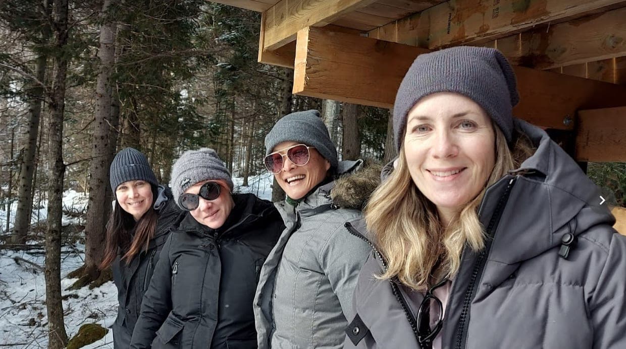 Friends in winter jackets under the deck
