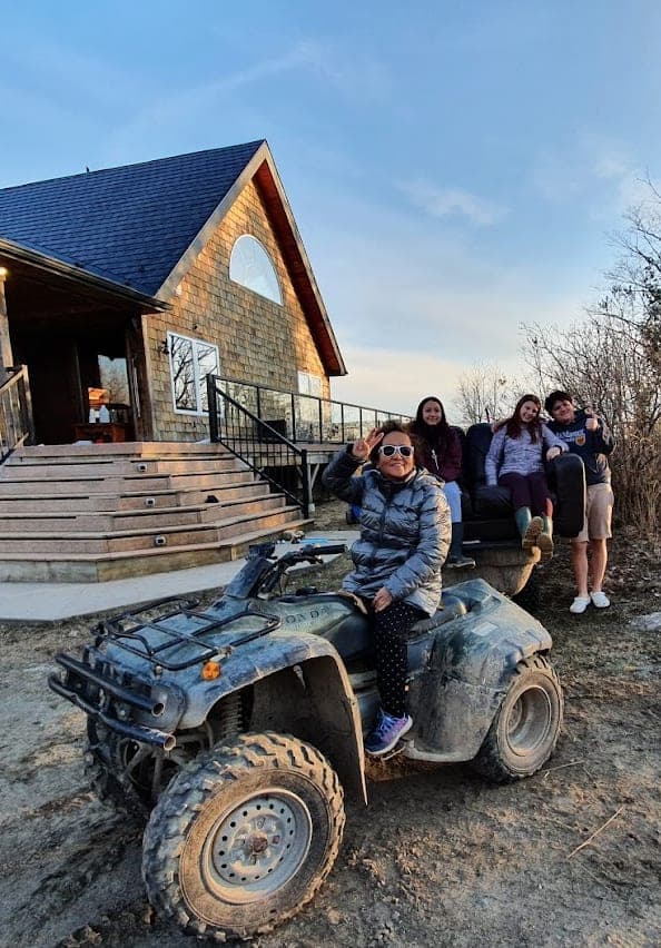 Riding an ATV beside the cottage