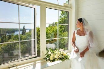 Bride by the window overlooking the lake