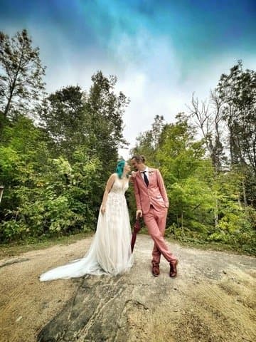 Couple posing on the rock outcrop