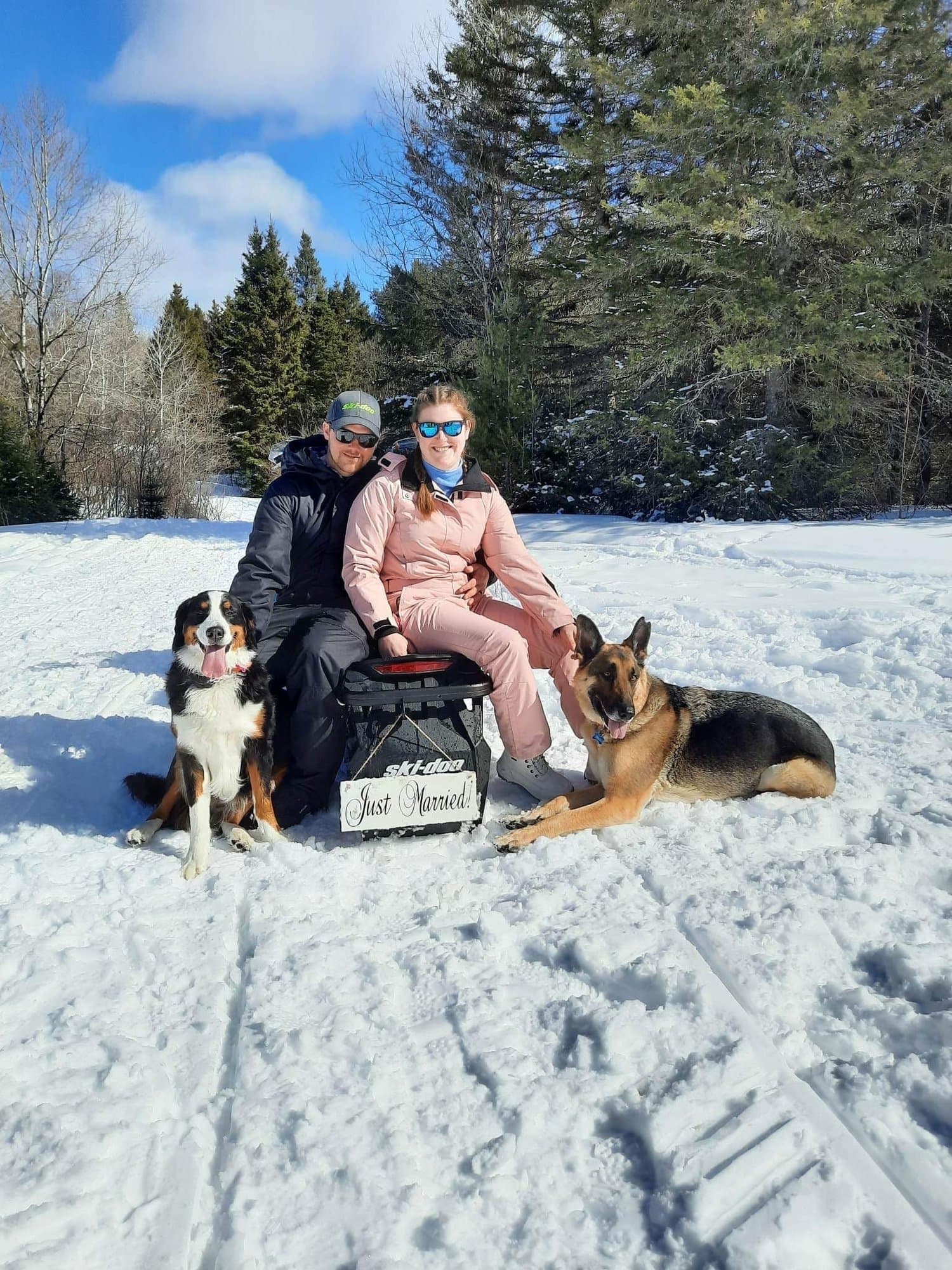 Couple with their dogs in the snow