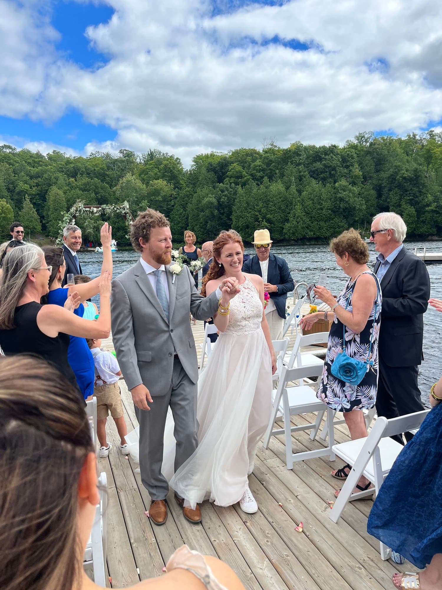 Newlyweds walking down the dock