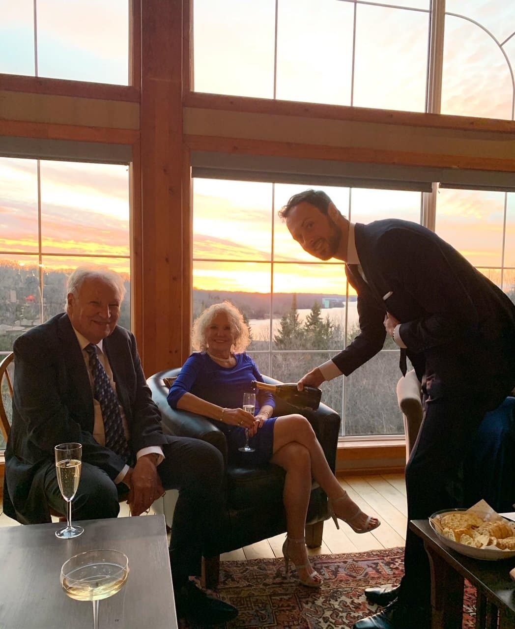 Guests celebrating in the great room at sunset