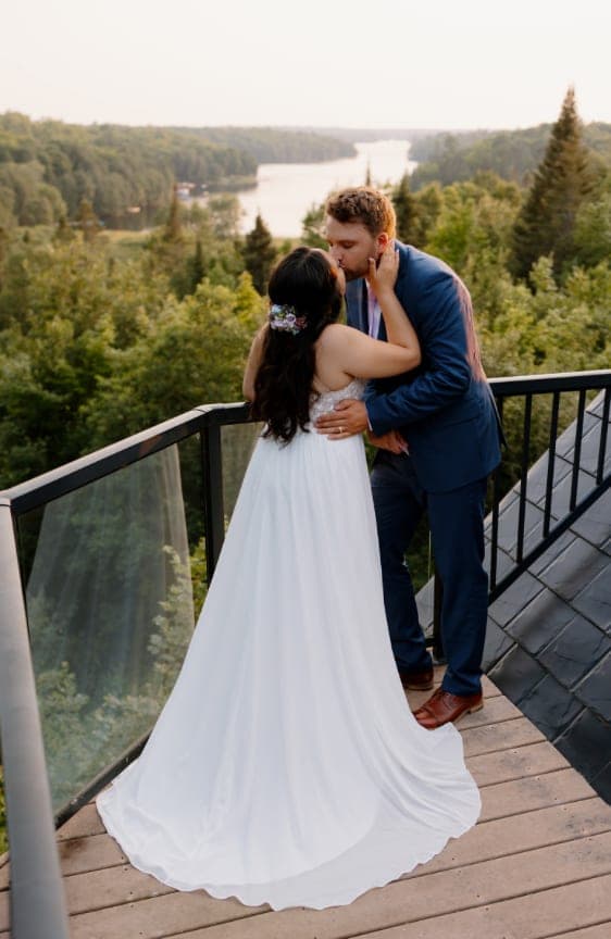 Couple kissing on the deck above the valley