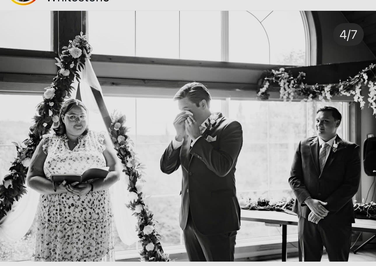 Groom wiping a tear during the ceremony