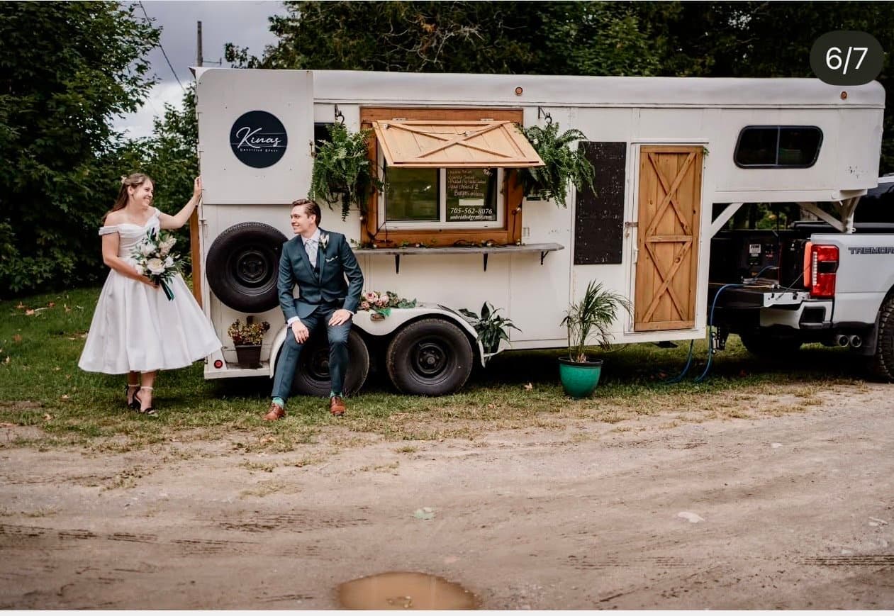 Couple beside a vintage bar trailer