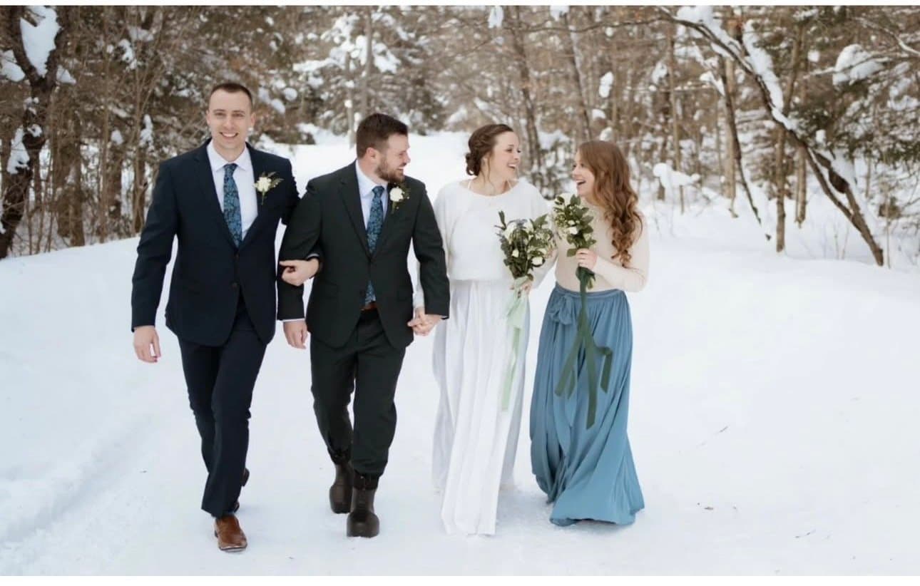 Wedding party walking in the snow