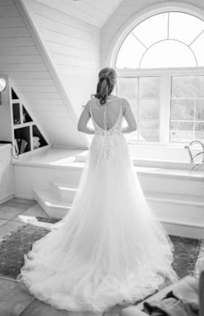 Bride by the arched window in black and white